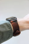 Seitenansicht einer Apple Watch am Handgelenk mit einem Lederband in Camo.